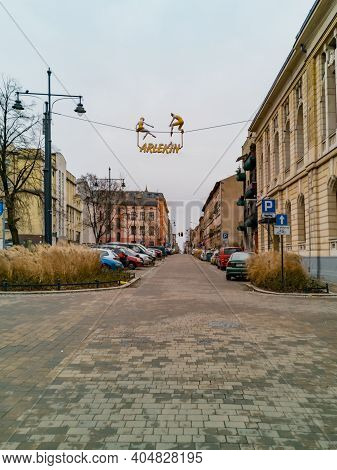 Lodz, Poland - February 23 2020 Hanging Sign Of Puppet Theater Arlekin Over Street