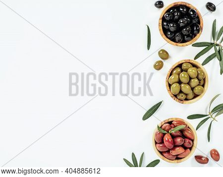 Set Of Green Olives, Black Olives And Red Kalmata Olives On White Background, Copy Space. Top View O