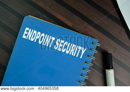 The Book Of Endpoint Security Isolated On Wooden Table.
