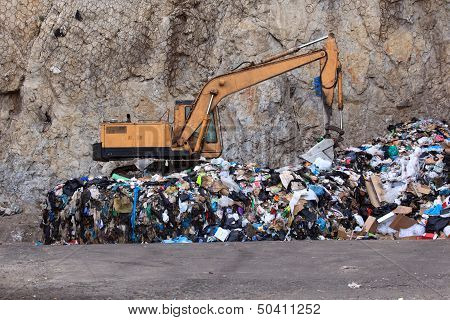 Escavator At Garbage Dump