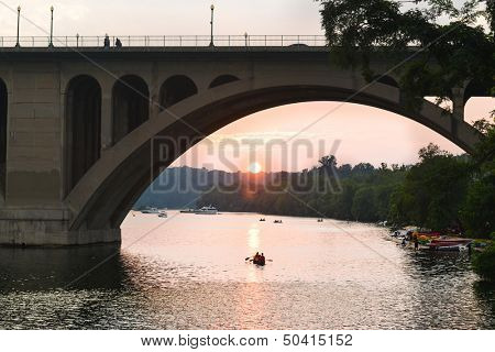 Washington DC - Key Bridge silhouette with kayaking people in Potomac River