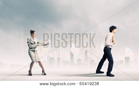 Image of three businesspeople with rope against diagram background