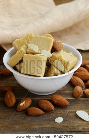 almond paste - marzipan in a bowl with whole nuts