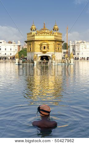 Sikh prayer in pond of Golden Temple in Amritsar, Punjab, India.