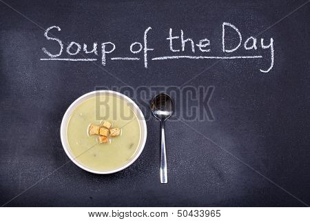 Chalkboard advertising the soup of the day, with a bowl of leek and potato soup and spoon, garnished with bread croutons, and space for your text