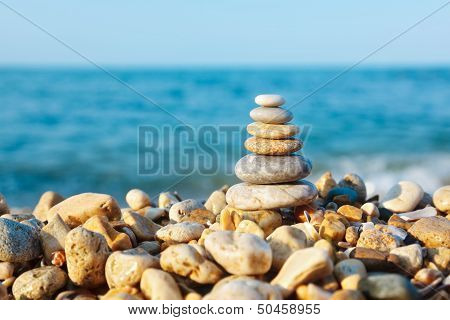 Stacked Pebbles On The Sea Side