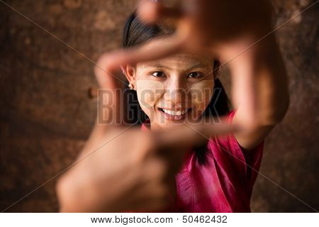 Beautiful young traditional Myanmar girl playing fun.
