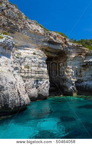 Pirate coast cliff cave at Menorca island, Spain.