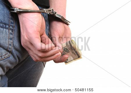 Handcuffs On Hands With Money Closeup