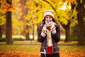 beautiful woman freezing in autumn park, cold autumn