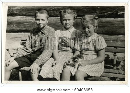 MOSCOW, USSR - CIRCA 1950s : An antique photo shows two little girls and their brother. 