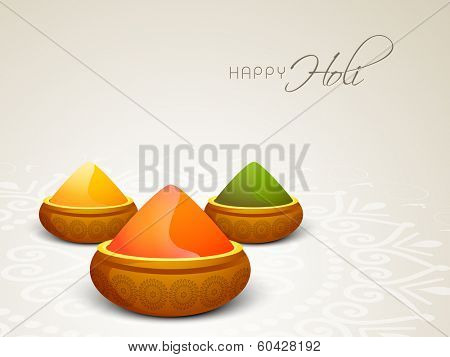 Indian festival Happy Holi celebrations concept with colour powders on beautiful floral decorated background.
