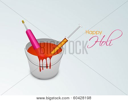 Indian festival Happy Holi celebrations concept with colour bucket and pichkari on grey background. 