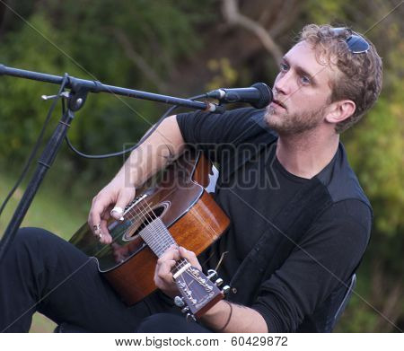 Young Man Singing with Guitar