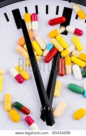 colorful capsules on a clock, symbol photo for healthcare, healthcare reform, reform backlog