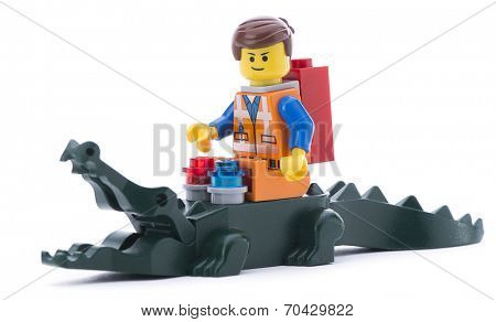 Ankara, Turkey - March 15, 2014 : Lego movie minifigure character Emmet riding alligator isolated on white background. 
