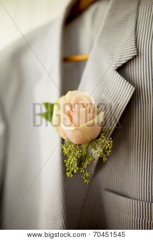rose boutonniere on seersucker jacket