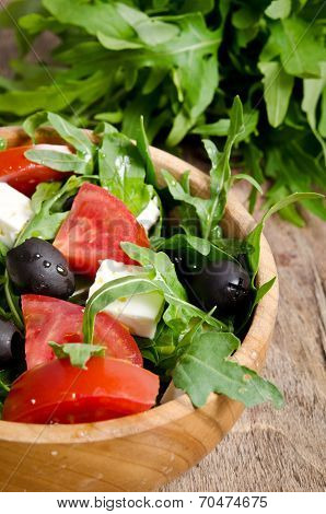 Greek Salad In A Wooden Salad Bowl On The Table