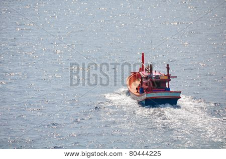 Fishing boat heading out to the gulf in the early morning