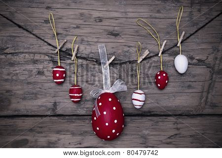 Many Red And White Easter Eggs And One Big Egg Hanging On Line Frame