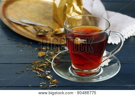 Beautiful vintage composition with herbal tea, on wooden table