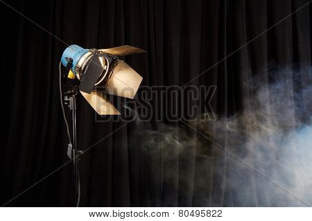 Photo studio lighting equipment on black background with smoke