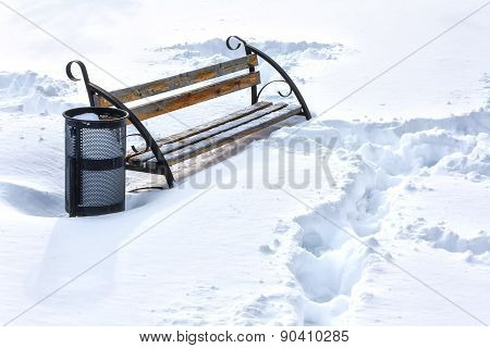 Lonely Bench In Winter Snow Covered Park