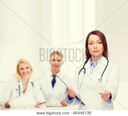 healthcare and medicine concept - calm female doctor with clipboard and stethoscope