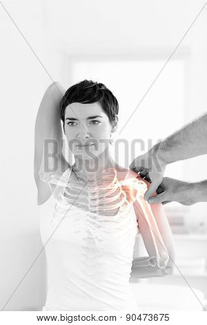 Digital composite of Highlighted bones of woman at physiotherapist