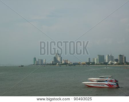 Bay with sailing boat and the buildings on the far side