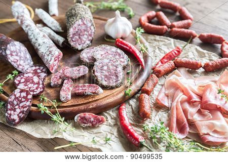Different Kinds Of Sausage On The Wooden Background