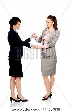 Businesswoman giving a plane to her partner.
