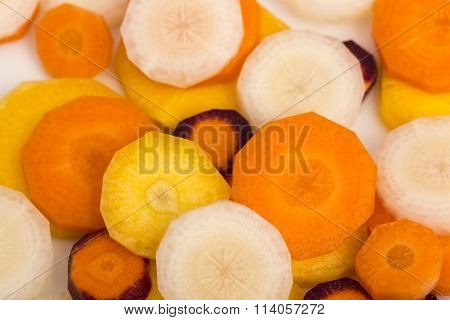 raw yellow, white, orange, red carrots