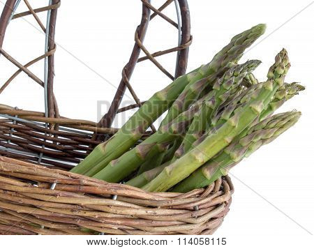 Green asparagus in a basket, isolated
