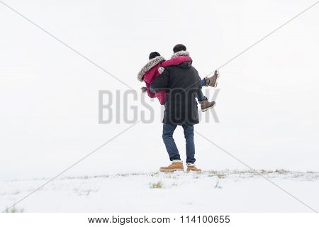 Two teenagers havinf fun on the snow field