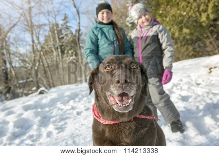 girls with dog in winter park