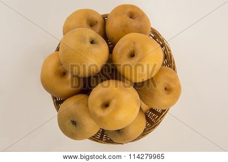 Some Asian Pears Over A White Background.