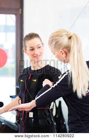Female coach dress woman in ems electro muscular stimulation costume 