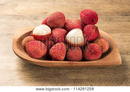 Fresh Lychees On Wooden Surface.