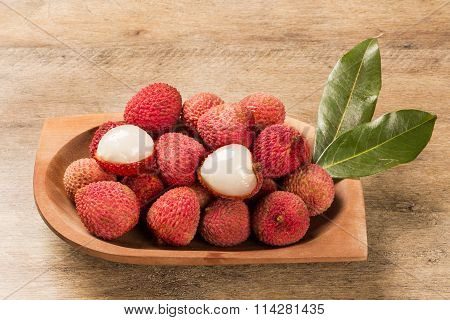 Fresh Lychees On Wooden Surface.