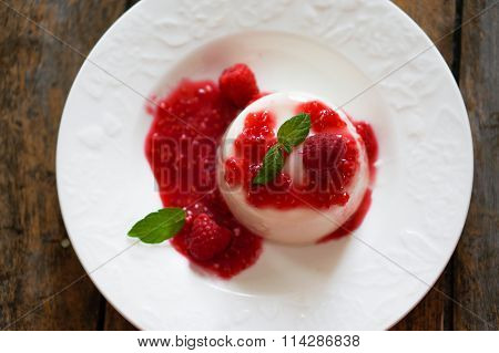 Delicious Italian Dessert Panna Cotta With Raspberry Sauce And Mint On White Background