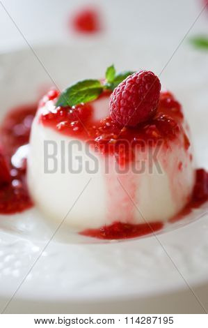 Delicious Italian Dessert Panna Cotta With Raspberry Sauce And Mint On White Background
