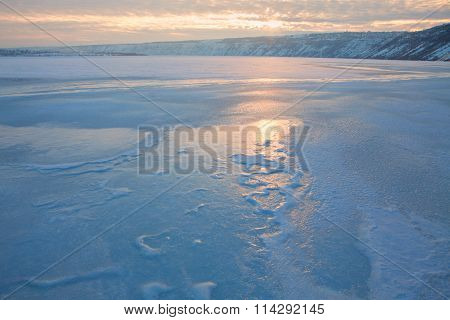 sunrise over frozen lake