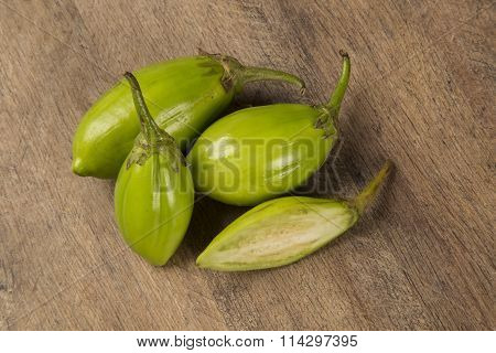 Some Green African Eggplants Over A Wooden Surface