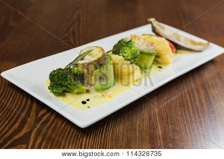 Fish with vegetables. Beautiful layout on a plate