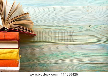 Open book, hardback books on wooden table. Back to school. Copy space