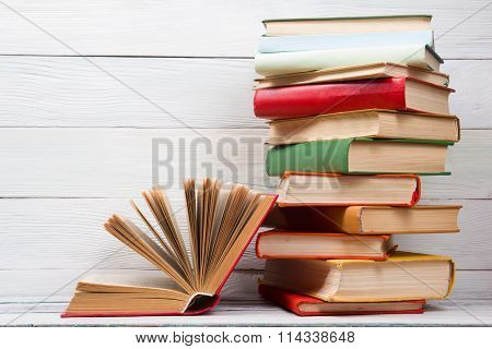 Open book, hardback books on wooden table. Back to school. Copy space