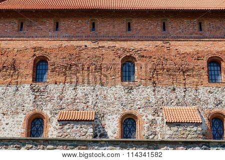 Exterior of the Trakai castle old brick wall with a windows in Trakai, Lithuania.