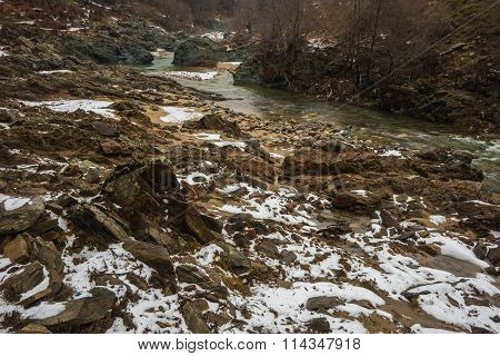 River With Green Waters, Snow And Ice Near Xanthi In Greece