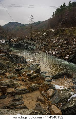 River With Green Waters, Snow And Ice Near Xanthi In Greece